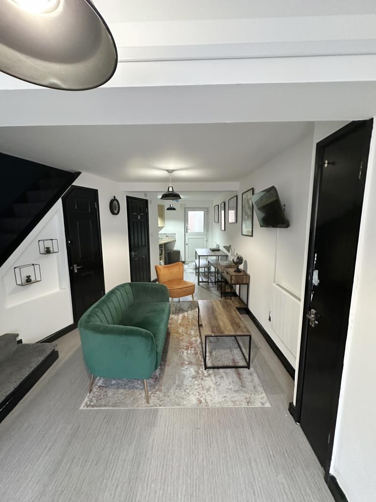 Lot: 70 - TOWN CENTRE BUILDING WITH OFF-ROAD PARKING - Ground floor with white walls and grey flooring